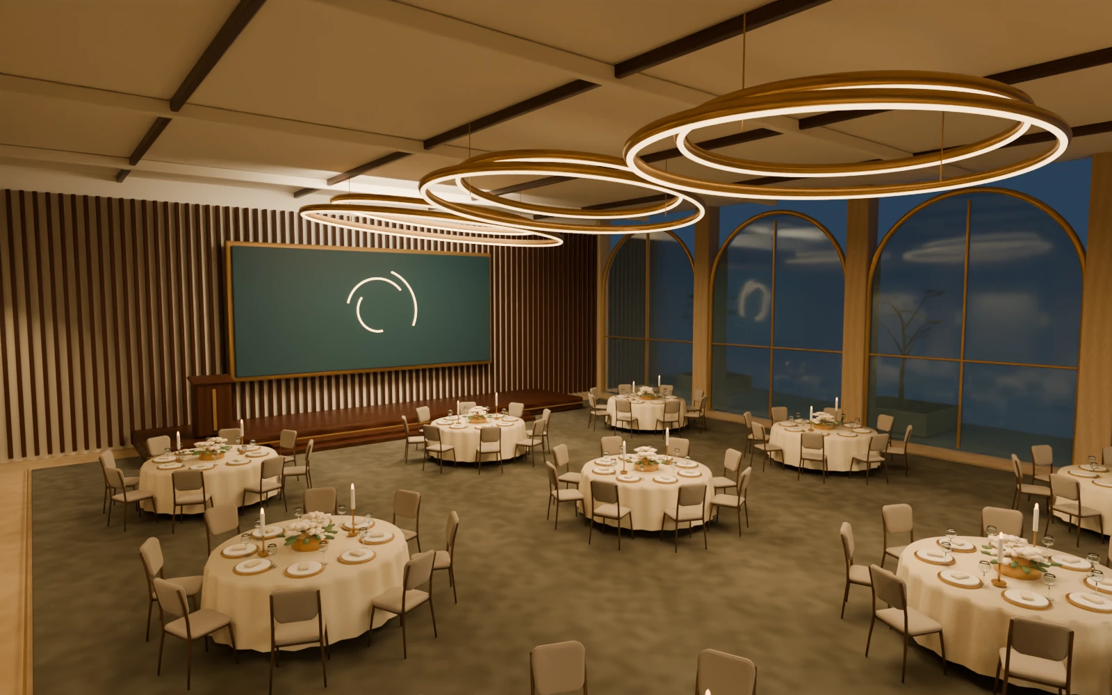 Aurelia Hall hotel ballroom with round gala tables, a stage and warm interior lighting